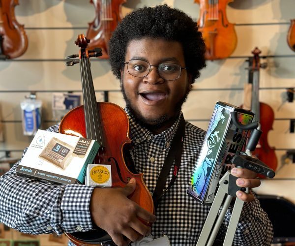 Jelani at Heid Music with arms full of accessories!