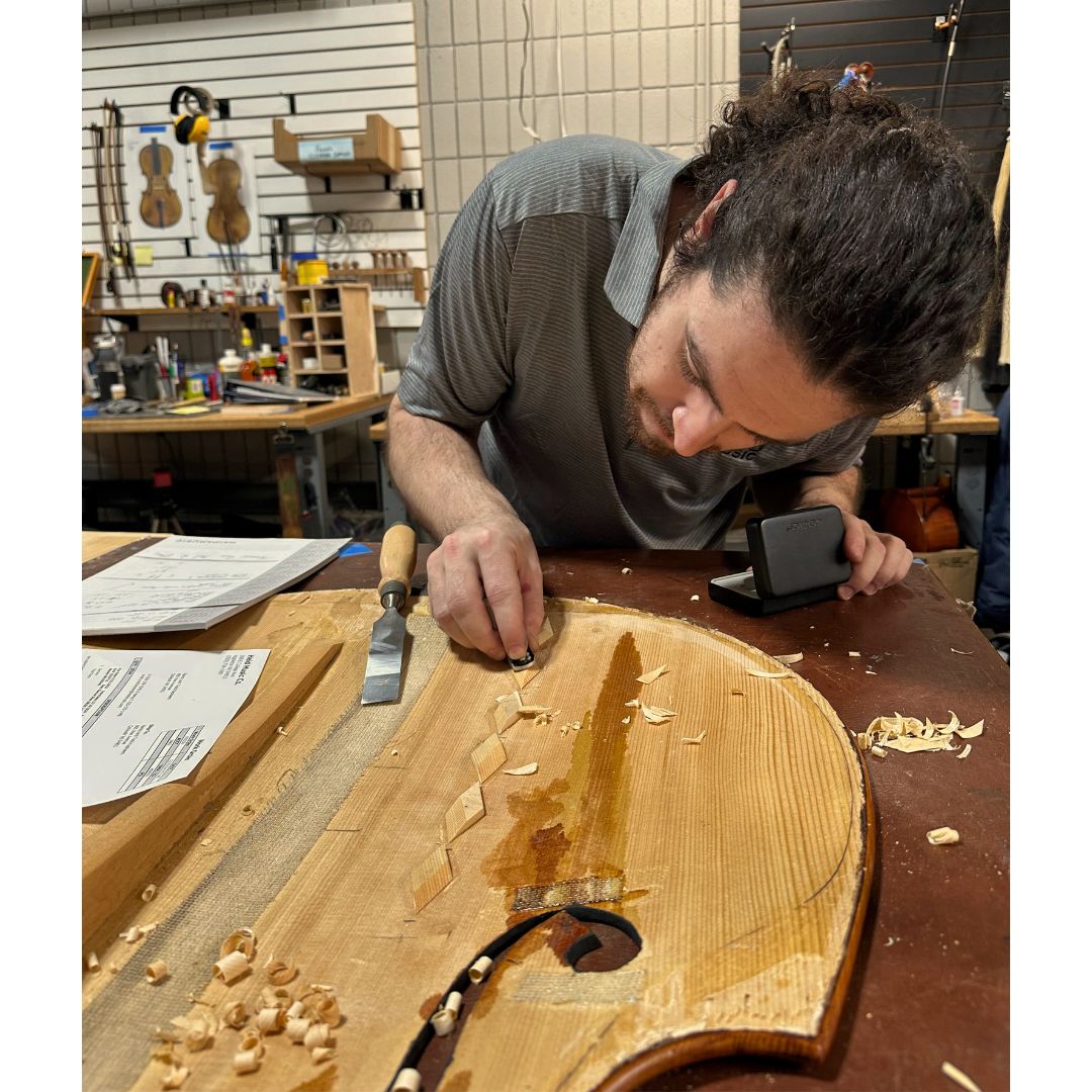 Luthier at work on orchestra instrument